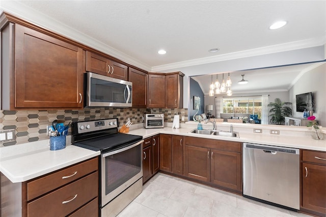 kitchen with a sink, light countertops, appliances with stainless steel finishes, tasteful backsplash, and crown molding