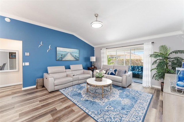 living area featuring vaulted ceiling, baseboards, wood finished floors, and crown molding