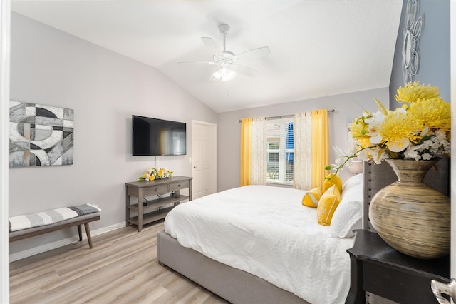 bedroom featuring vaulted ceiling, ceiling fan, light wood finished floors, and baseboards