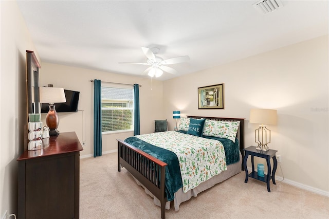 bedroom featuring light carpet, ceiling fan, visible vents, and baseboards