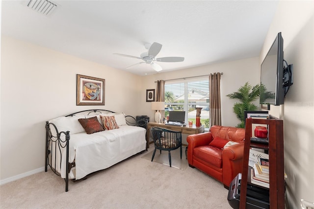 bedroom with light carpet, ceiling fan, visible vents, and baseboards