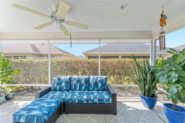 sunroom / solarium featuring ceiling fan