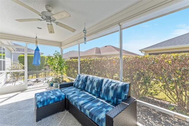 sunroom / solarium featuring a ceiling fan