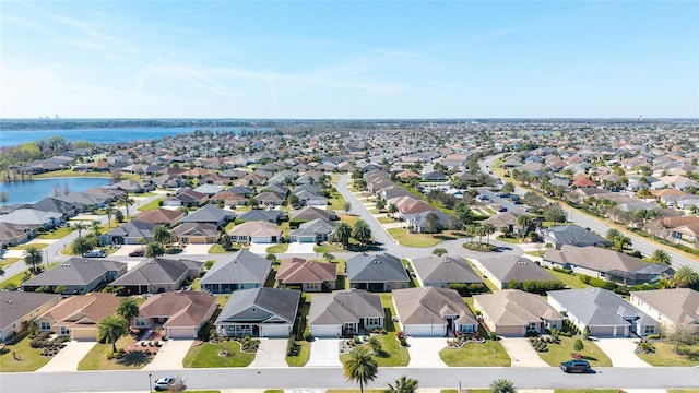 drone / aerial view featuring a residential view and a water view