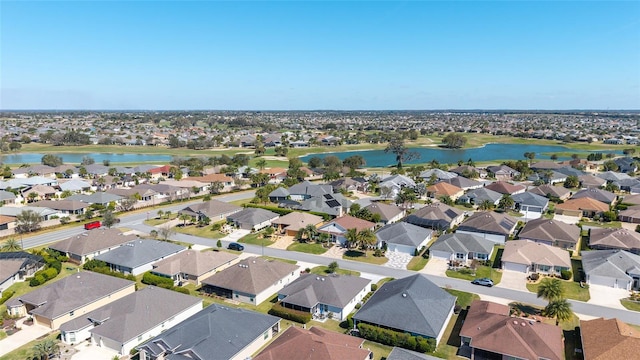 birds eye view of property with a water view and a residential view