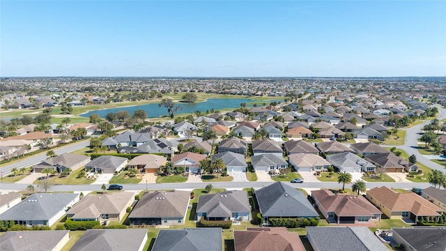 bird's eye view featuring a water view and a residential view