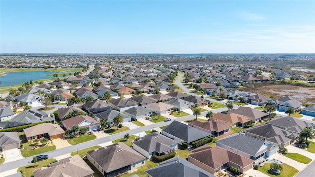 birds eye view of property featuring a residential view and a water view