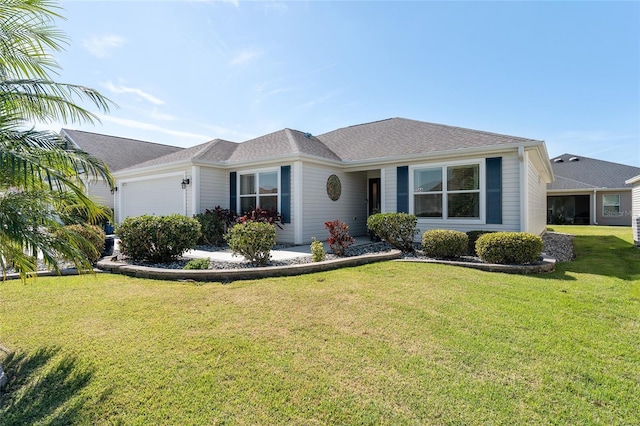 ranch-style home featuring an attached garage and a front yard