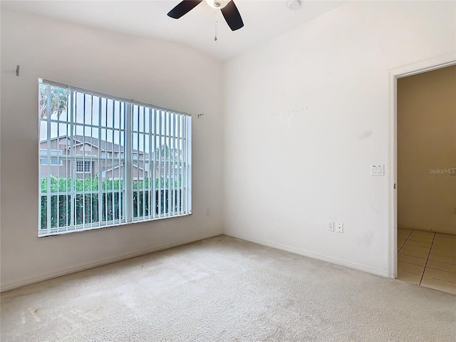 unfurnished room with carpet flooring, ceiling fan, and baseboards