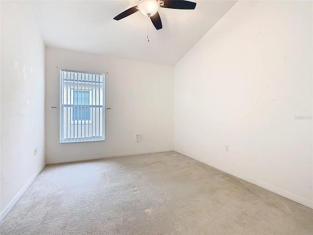 spare room with a ceiling fan and light colored carpet