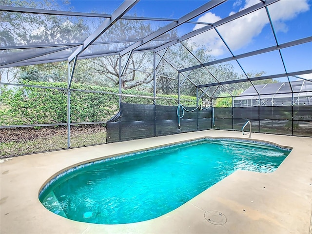 view of pool with a lanai, a fenced in pool, and a patio