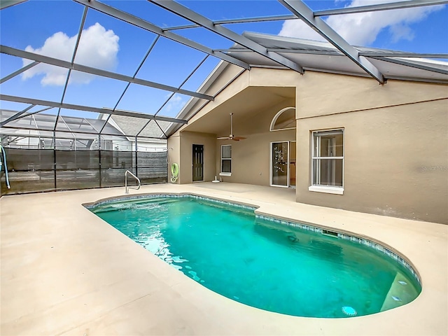 outdoor pool featuring a lanai, ceiling fan, and a patio