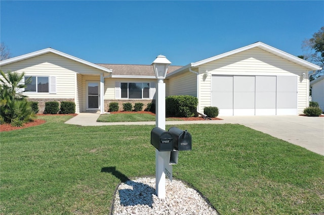 ranch-style house with driveway, brick siding, and a front yard