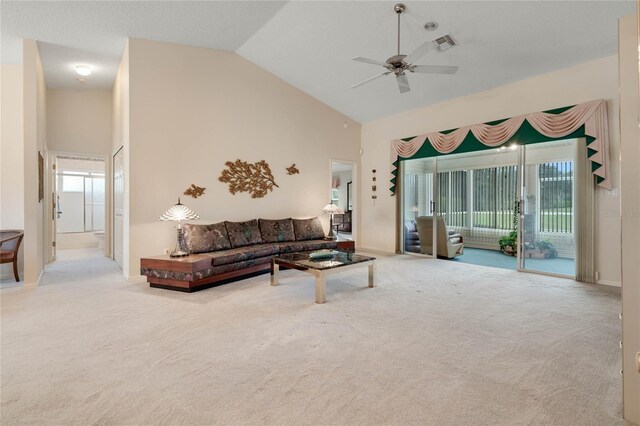 25274 Lost Oak Cir, Leesburg, FL 34748 - living room featuring high vaulted ceiling, visible vents, light carpet, and a ceiling fan