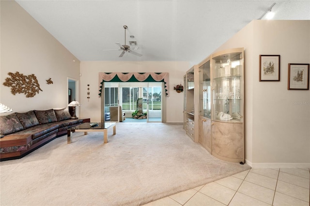 25274 Lost Oak Cir, Leesburg, FL 34748 - living area with light tile patterned floors, light colored carpet, ceiling fan, vaulted ceiling, and track lighting