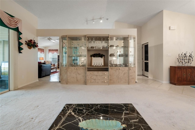 25274 Lost Oak Cir, Leesburg, FL 34748 - unfurnished living room featuring lofted ceiling, light tile patterned floors, a textured ceiling, and light colored carpet