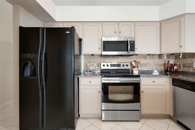 25274 Lost Oak Cir, Leesburg, FL 34748 - kitchen with stainless steel appliances, tasteful backsplash, dark stone countertops, and light tile patterned flooring