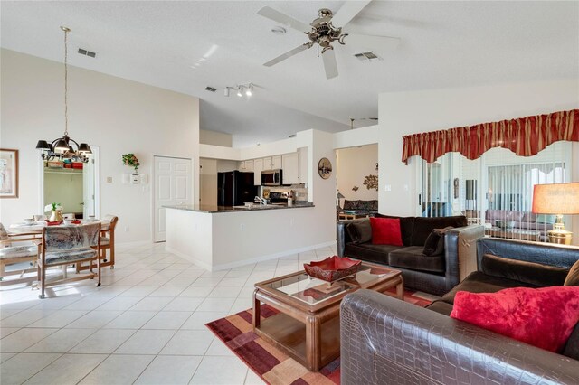 25274 Lost Oak Cir, Leesburg, FL 34748 - living room with ceiling fan with notable chandelier, visible vents, vaulted ceiling, and light tile patterned flooring