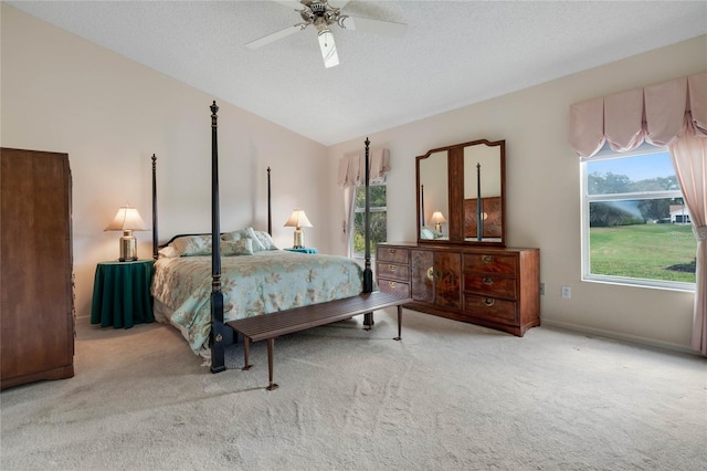 25274 Lost Oak Cir, Leesburg, FL 34748 - bedroom with light carpet, baseboards, ceiling fan, vaulted ceiling, and a textured ceiling
