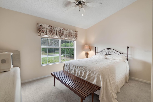25274 Lost Oak Cir, Leesburg, FL 34748 - bedroom featuring light carpet, a textured ceiling, lofted ceiling, and baseboards