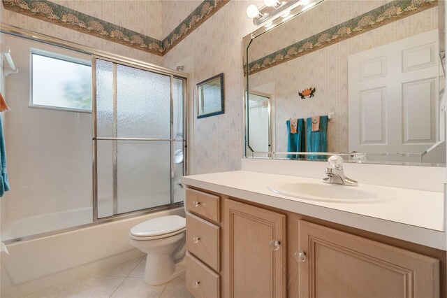 25274 Lost Oak Cir, Leesburg, FL 34748 - bathroom featuring wallpapered walls, toilet, enclosed tub / shower combo, vanity, and tile patterned floors