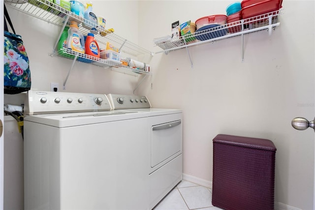 25274 Lost Oak Cir, Leesburg, FL 34748 - laundry room with laundry area, washing machine and dryer, light tile patterned floors, and baseboards
