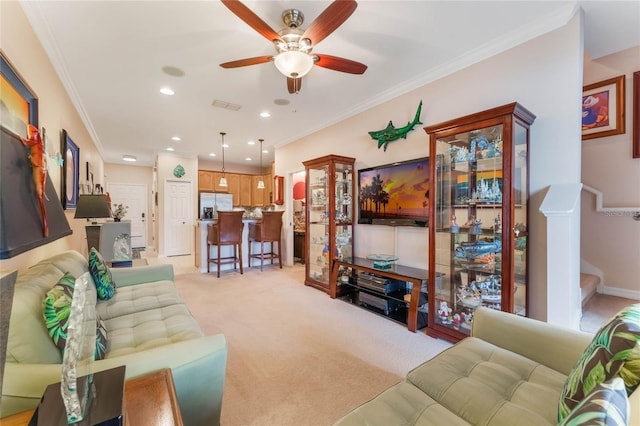 living area with ornamental molding, light colored carpet, visible vents, and stairs