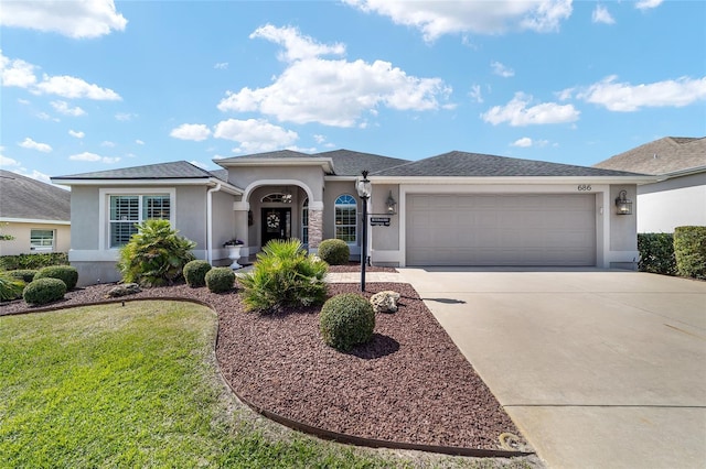 view of front of home with concrete driveway, roof with shingles, an attached garage, and stucco siding