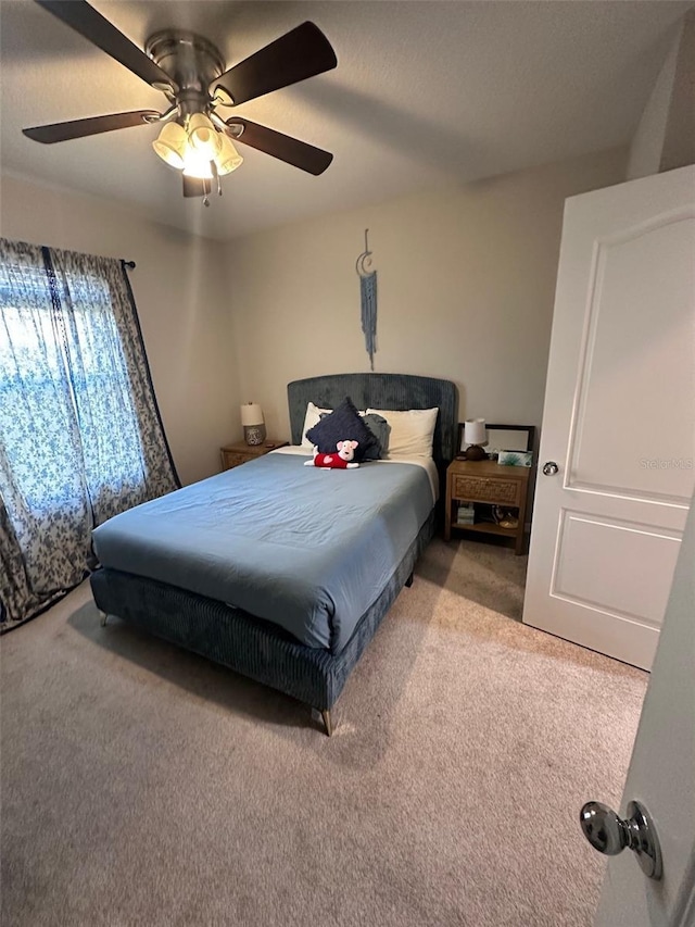bedroom featuring light carpet and ceiling fan