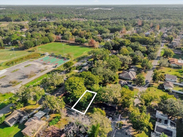 birds eye view of property featuring a wooded view