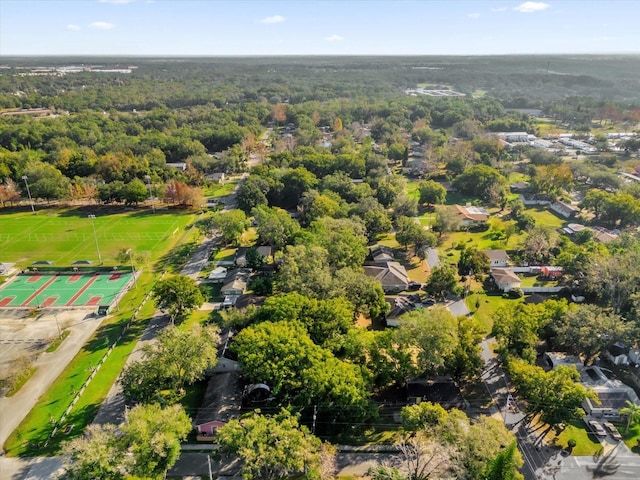 birds eye view of property with a view of trees