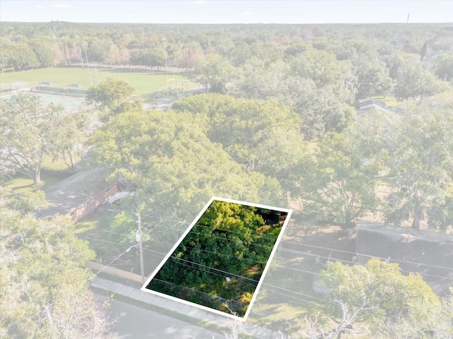 birds eye view of property featuring a view of trees