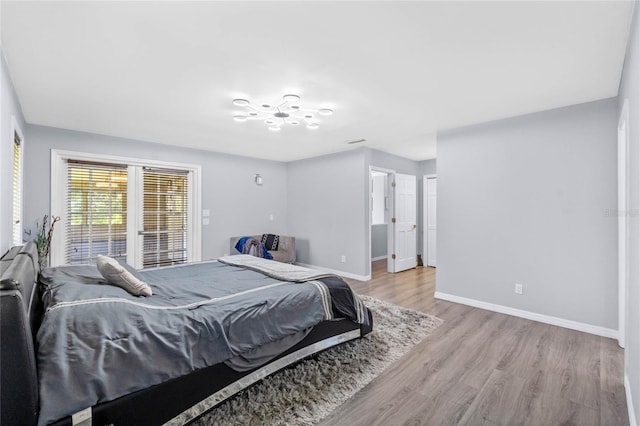 bedroom with baseboards and wood finished floors