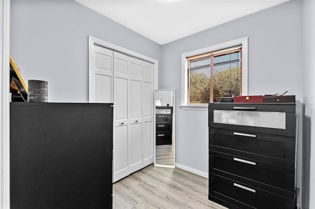 interior space featuring light wood-style flooring and baseboards