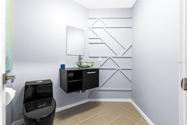 bathroom featuring vanity and baseboards