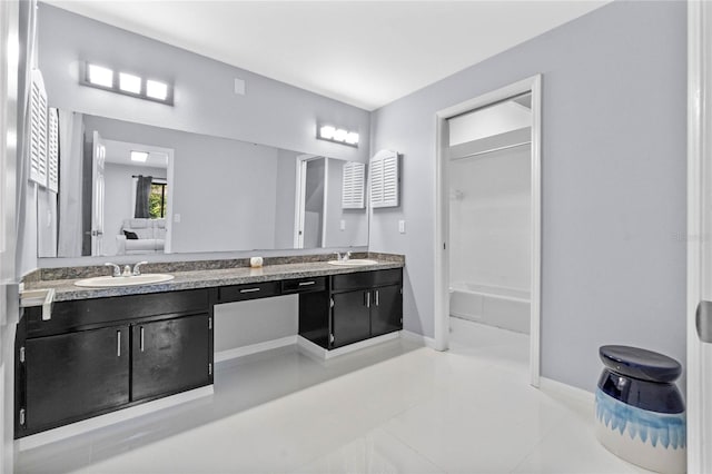 full bathroom with double vanity, shower / bathtub combination, baseboards, and a sink