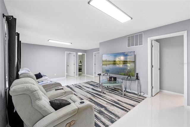 living area featuring baseboards and visible vents