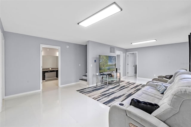 living room featuring visible vents, stairway, and baseboards