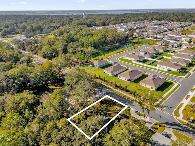 aerial view featuring a wooded view and a residential view