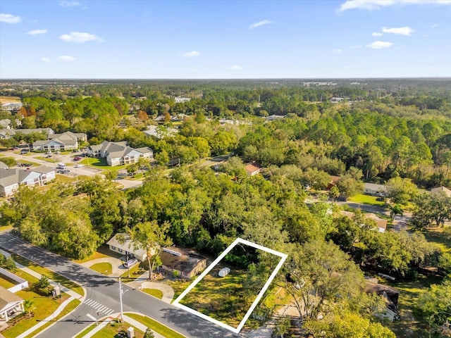 bird's eye view featuring a forest view and a residential view