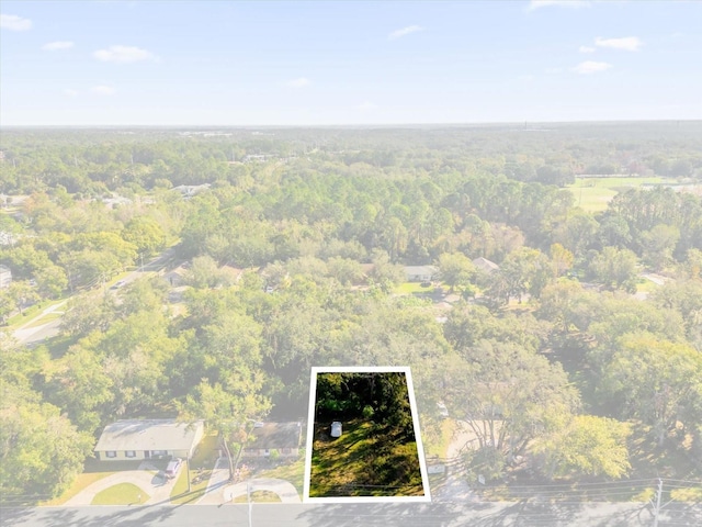 drone / aerial view featuring a view of trees