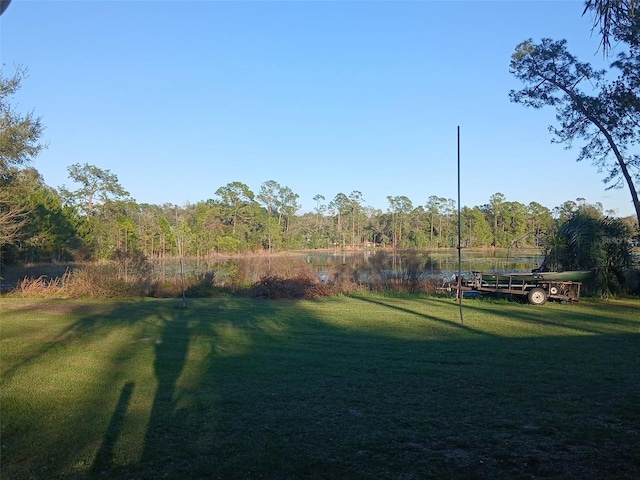 view of yard with a view of trees