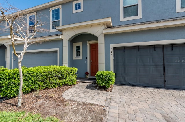 view of front of property with a garage and stucco siding