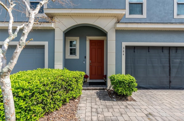 view of exterior entry featuring stucco siding