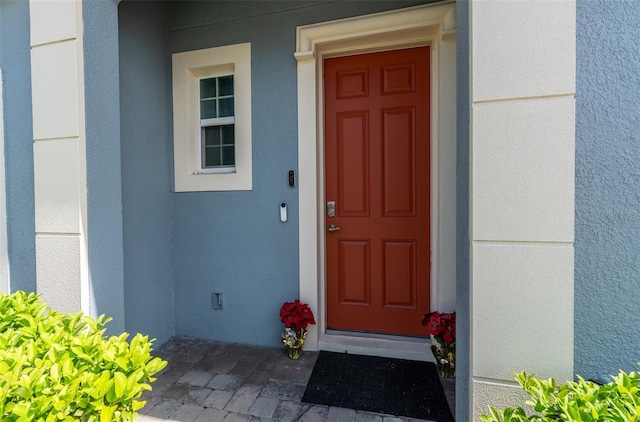 entrance to property with stucco siding