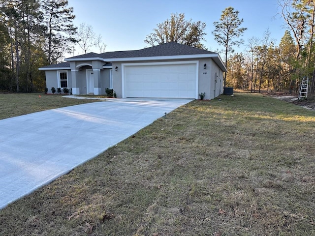 ranch-style house featuring a garage, a front lawn, and stucco siding