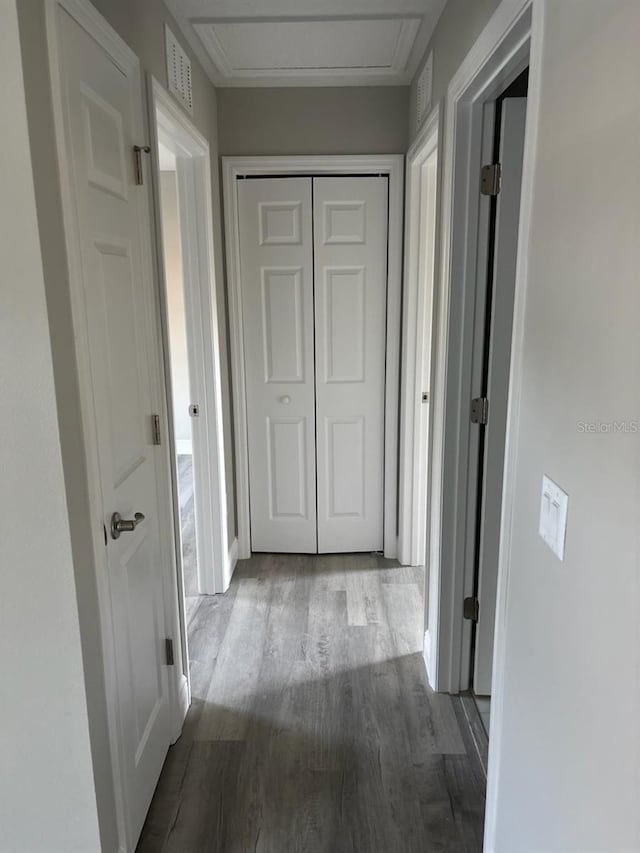 hall featuring light wood finished floors and visible vents