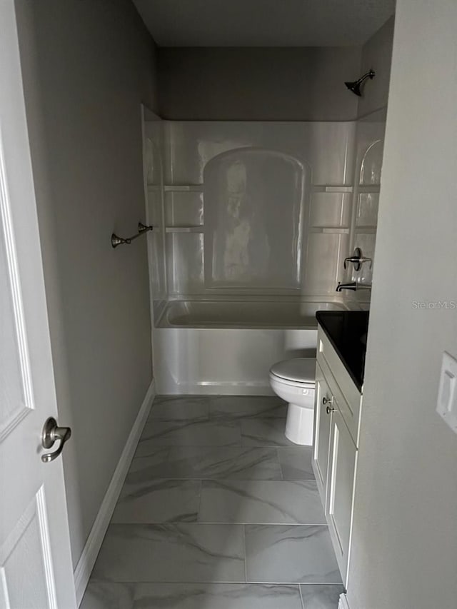 bathroom with marble finish floor, shower / bath combination, toilet, vanity, and baseboards