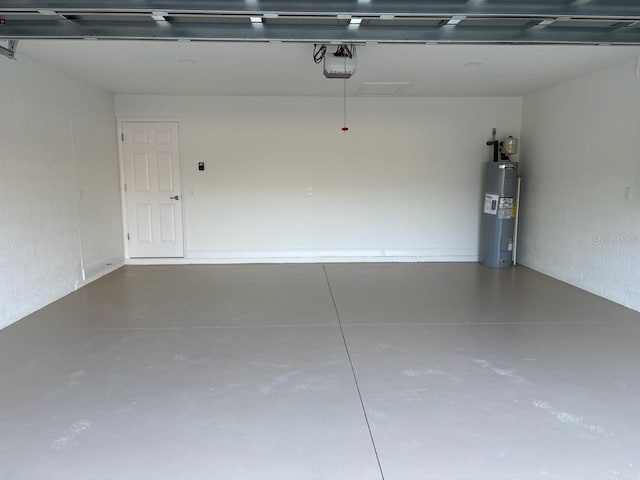 garage featuring a garage door opener and electric water heater