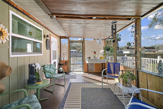 sunroom with wooden ceiling and plenty of natural light